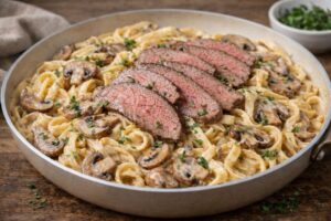creamy mushroom pasta with sliced beef and thyme
