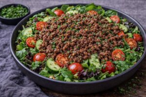 ground beef salad with warm beef greens tomatoes and cucumber