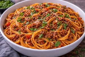 ground beef spaghetti with tomato sauce and fresh basil