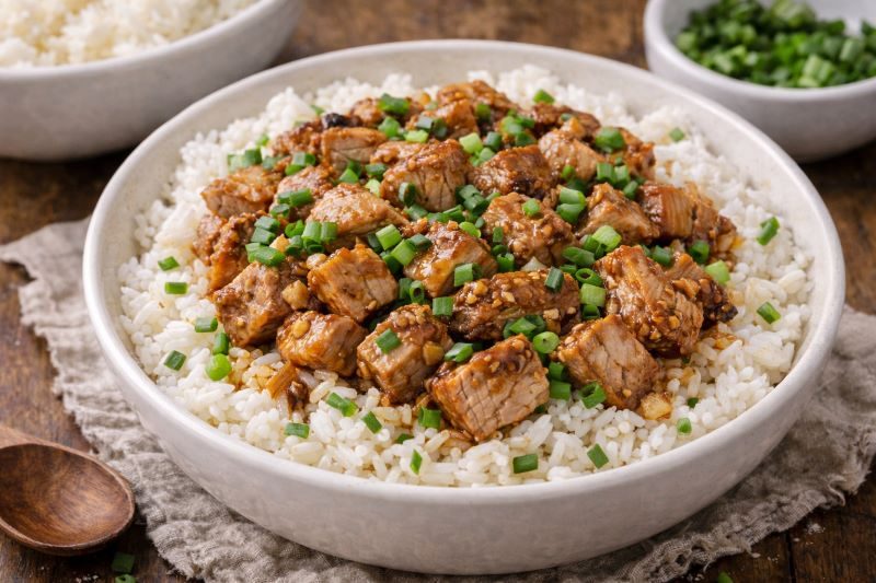 garlic pork loin rice bowl with diced pork white rice and green onions