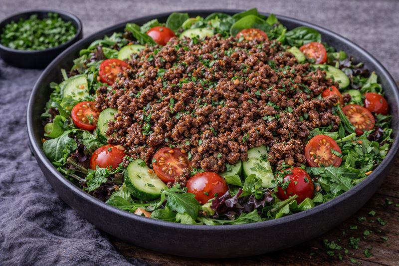 ground beef salad with warm beef greens tomatoes and cucumber